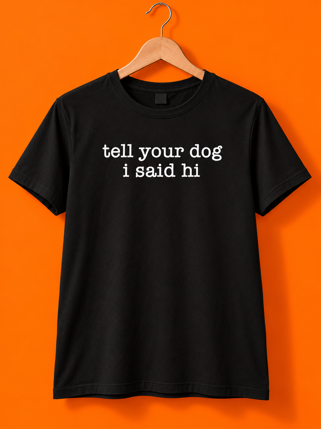 Tell Your Dog I Said Hi black tee on a hanger